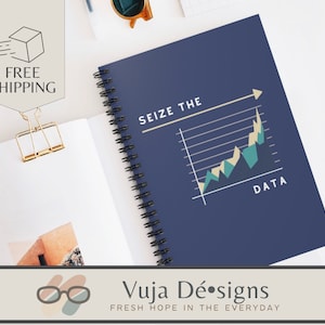 May include: A blue spiral bound notebook with a graph and the text "Seize the Data" on the cover. The notebook has a white background with a black spiral binding.