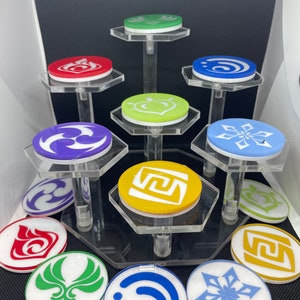 May include: A set of 10 colorful round tokens with different symbols on a clear acrylic display stand. The tokens are green, red, yellow, purple, blue, and white.