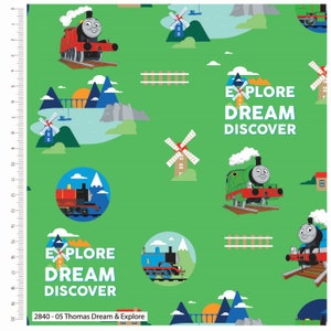 May include: A green fabric with a repeating pattern of Thomas the Tank Engine, windmills, and mountains. The text "Explore Dream Discover" is repeated throughout the fabric.