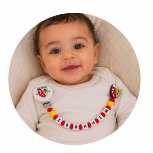 RCL Lens Football pacifier clip - a great gift idea for a newborn at a low price