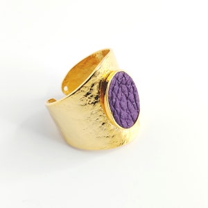 Adjustable golden ring decorated with purple leather