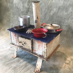 Antique children&#39;s stove  with pans