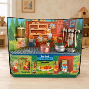 May include: A toy kitchen playset featuring a BearFamily graphic, a copper-colored kettle, a silver pot, a small frying pan, and hanging kitchen utensils. The backdrop displays a printed scene of bears baking in a kitchen, while the base shows bears playing on a swing and relaxing in a hammock. The unit includes a blue control panel with knobs and a printed oven door.