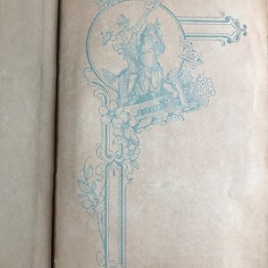 May include: A vintage book with a blue and white decorative design on the cover. The design features a soldier riding a horse and holding a flag.