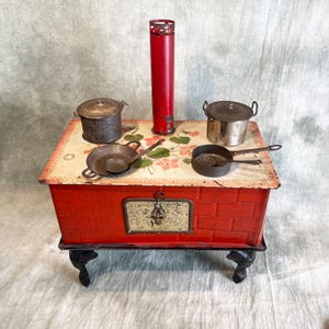 Antique children&#39;s stove  with pans