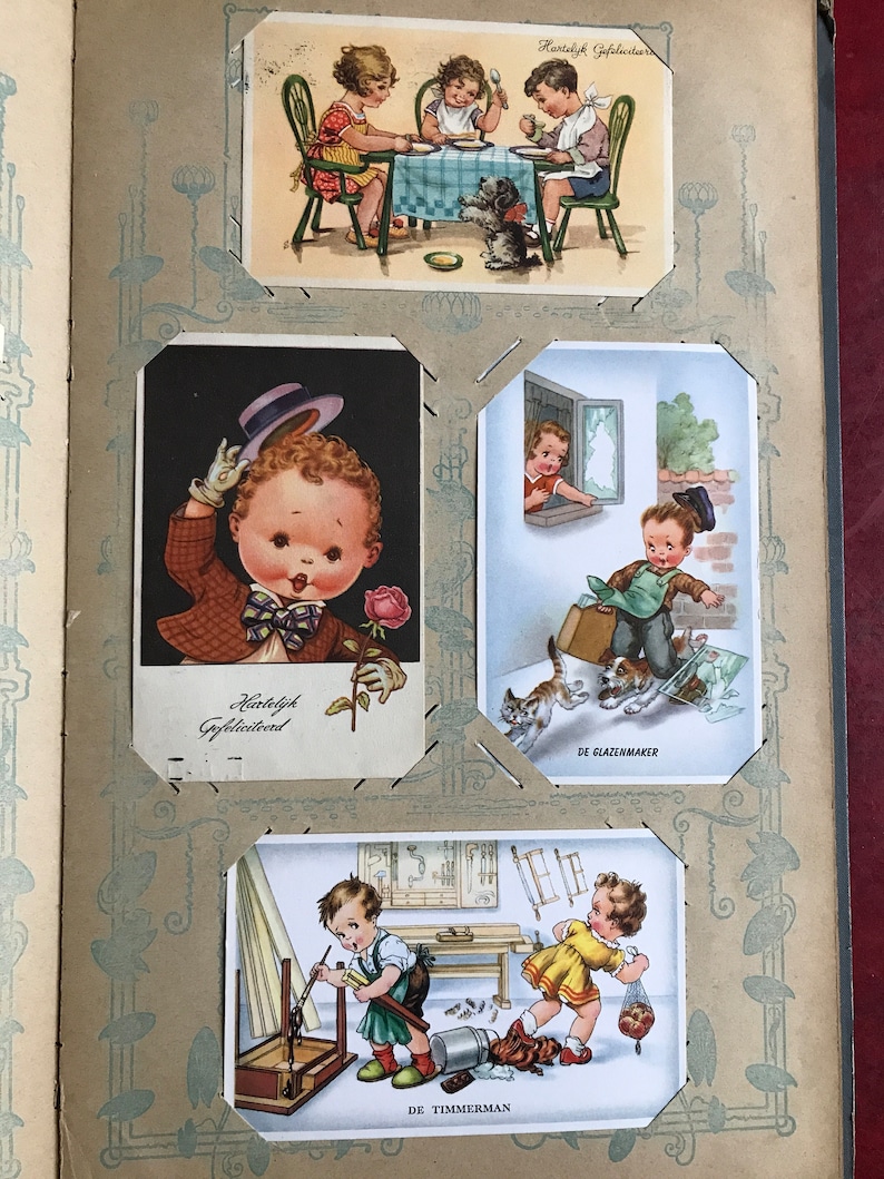 May include: A vintage scrapbook with illustrations of children in various scenes. The scrapbook has a brown cover with a decorative border and the text "Hartelijk Gefeliciteerd" on the front.