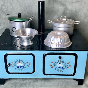 Antique children&#39;s stove 1930 with pans