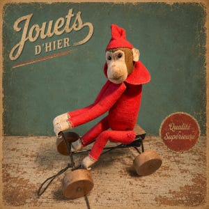 May include: A vintage-style plush monkey toy with a tan face and red felt body, wearing a matching red pointed hat. The monkey is seated on a small, black metal tricycle frame with four round wooden wheels. Text reads Jouets D'hier and Qualité Supérieure.