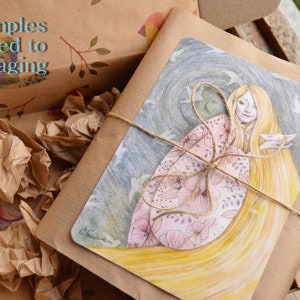 May include: A brown paper package tied with twine and decorated with a watercolor illustration of a woman with long flowing hair and a pink floral pattern. The illustration is set against a dark blue background with white birds flying around her.