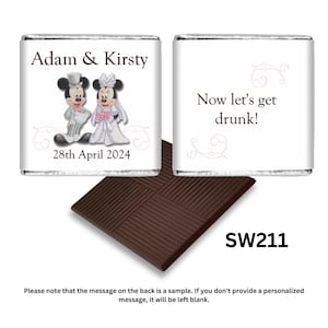 May include: A silver foil-wrapped chocolate bar with a personalised wedding message featuring Mickey and Minnie Mouse dressed in wedding attire. The front of the bar says "Adam & Kirsty" and "28th April 2024". The back of the bar says "Now let's get drunk!" and "SW211".