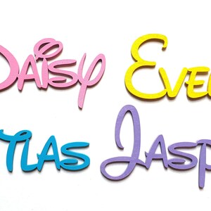 May include: Four wooden names, "Daisy", "Evelyn", "Atlas", and "Jasper", are cut in a Disney-style font. The names are painted in pink, yellow, blue, and purple.