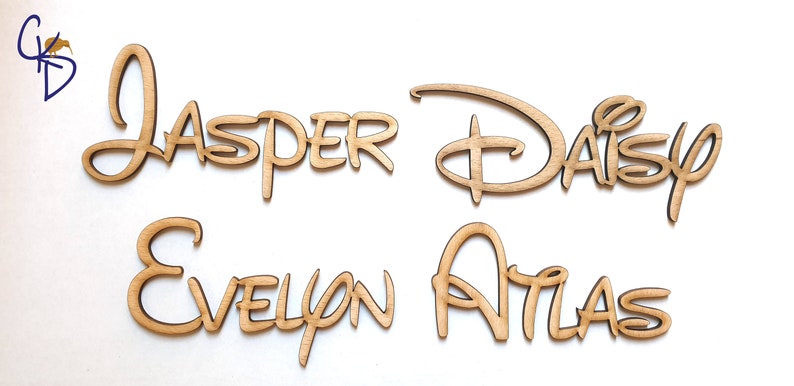 May include: Four wooden names in a Disney font style. The names are "Jasper", "Daisy", "Evelyn", and "Atlas".