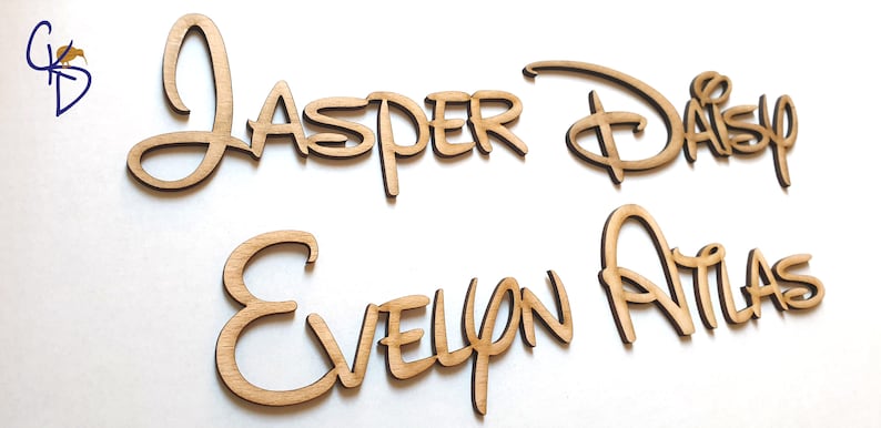 May include: Four wooden names in a cursive font. The names are "Jasper & Daisy" and "Evelyn Atlas".