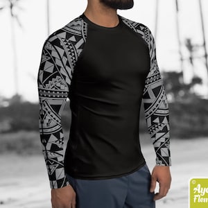 May include: Black long-sleeve shirt with a geometric pattern in white and gray on the sleeves. The shirt is made of a stretchy, athletic material.