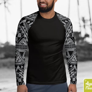 May include: Black long-sleeve shirt with a geometric pattern in gray on the sleeves. The shirt is made of a stretchy, moisture-wicking fabric.