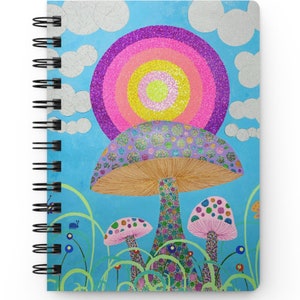 Puede incluir: Un cuaderno de espiral con una ilustración colorida de setas y un arcoíris sobre un fondo azul.