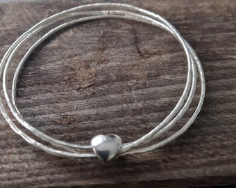 Hammered triple silver bangles with heart keeper bead, silver stacking bangles, handmade in the UK, postal gifts