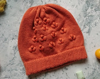Hand knitted orange beanie hat in merino wool with floral embroidery and crystal beads