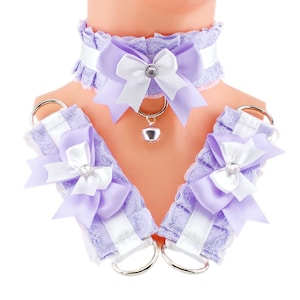 May include: A lavender and white lace choker with a bow and a bell charm. Matching lavender and white lace wrist cuffs with bows are also included.