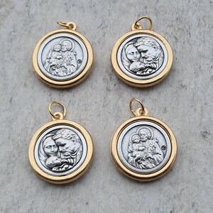 May include: Four gold-toned pendants with silver-toned images of a family. Each pendant features a different image of a man, woman, and child.