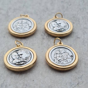 May include: Four silver and gold pendants with religious imagery. Each pendant features a different image of a holy family.