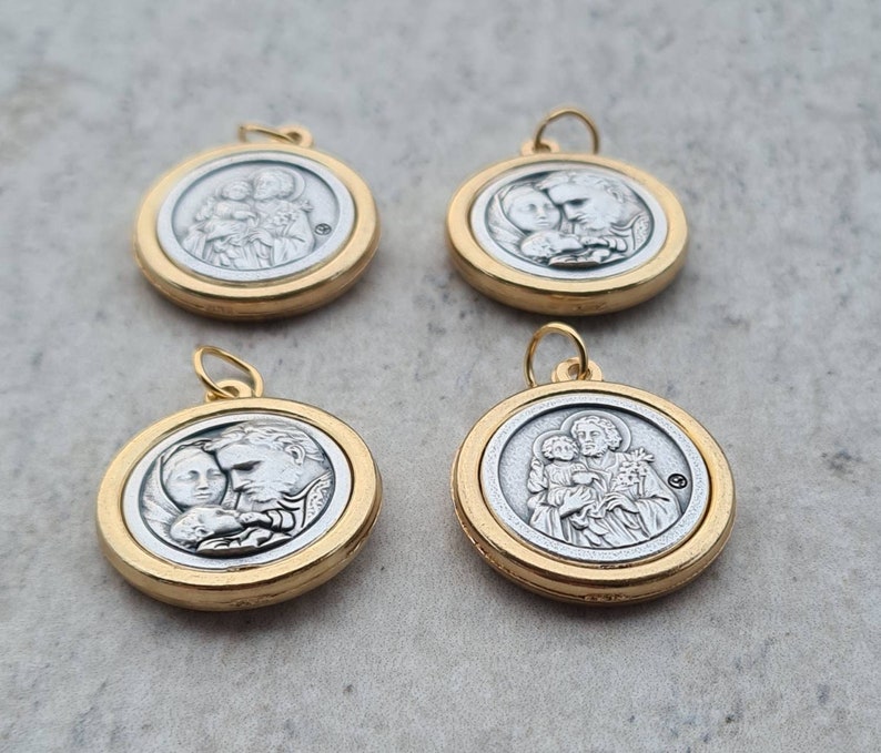 May include: Four silver and gold pendants with religious imagery. Each pendant features a different image of a holy family.