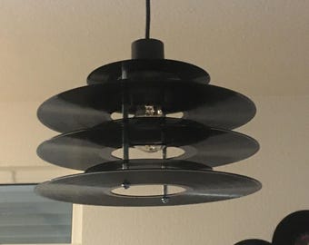 Handmade pendant lamp made from vinyl records, upcycled decor in industrial/retro style
