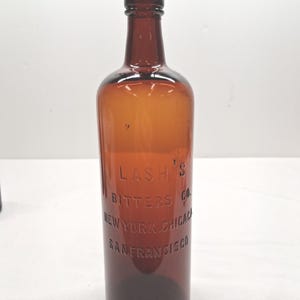 Antique amber glass bottle is a Lash's Bitters Co. bottle circa 1910