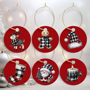 May include: Set of six Christmas-themed wine charms. Each charm features a red circular design with a gold hoop. Designs include a reindeer, gingerbread man, Santa, stocking, candle, and Santa hat, all with black and white plaid accents.