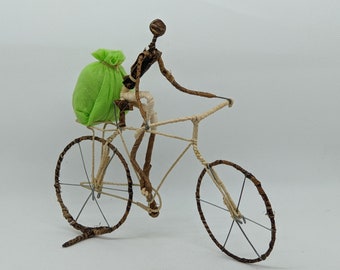 Model bike, cyclist with cloth bag