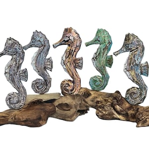 Painted wooden seahorse on stand.