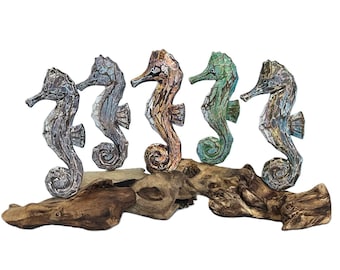 Painted wooden seahorse on stand.
