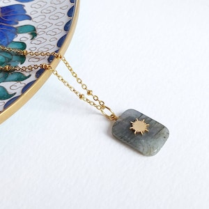 May include: A white ceramic mug with a black handle and the text "But First, Coffee" in a handwritten style. The mug is on a white surface. The mug is approximately 10 cm tall.