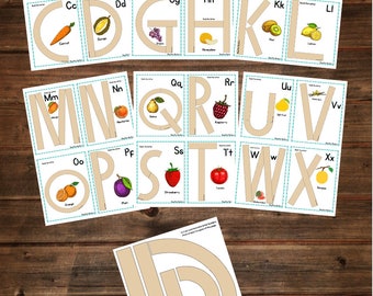 May include: A printable alphabet activity for kids featuring brown paper strips to build each letter. Each letter is paired with a fruit or vegetable, such as an apple for A, banana for B, and carrot for C.