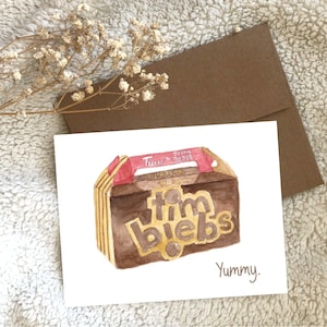 May include: A watercolor painting of a Timbits box from Tim Hortons. The box is brown with red and yellow accents. The text "Timbits" is written in gold letters on the box. The text "Yummy" is written in black below the box.