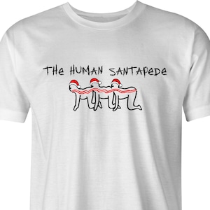 May include: White t-shirt with a black and red illustration of three people in Santa hats linked together, forming a human Santapede. The text "The Human Santapede" is printed above the illustration.