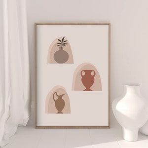 May include: A digital print featuring three abstract vases in shades of brown, orange, and pink. The vases are set against a white background and are framed in a light wood frame.