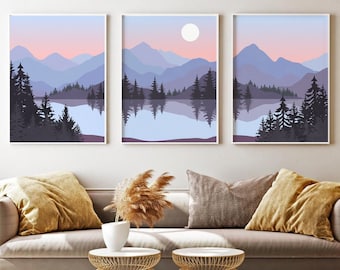 May include: Three framed prints of a purple and blue landscape with a lake and mountains. The prints are hanging on a white wall above a light brown couch with pillows.