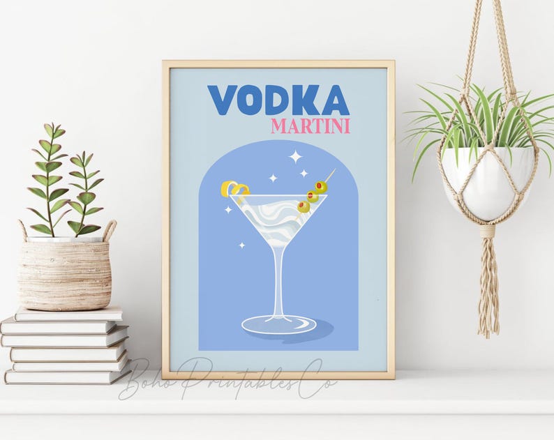 May include: A blue and white illustration of a vodka martini with a lemon twist and olives. The text "VODKA MARTINI" is in blue and pink letters.