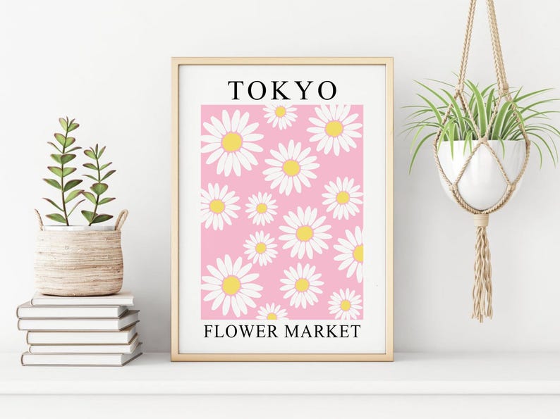 May include: A framed print with a pink background and white daisies. The print says "TOKYO FLOWER MARKET" at the bottom.