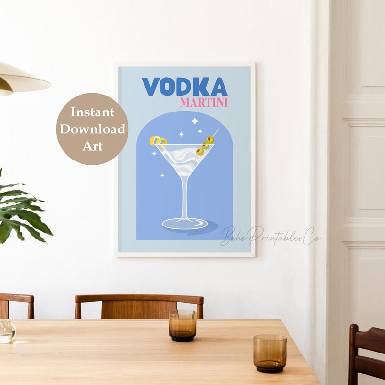 May include: A blue and white printable art print with the text "VODKA MARTINI" in bold blue letters. The print features a martini glass with a lemon twist and olives on a toothpick. The background is a light blue color with white stars.