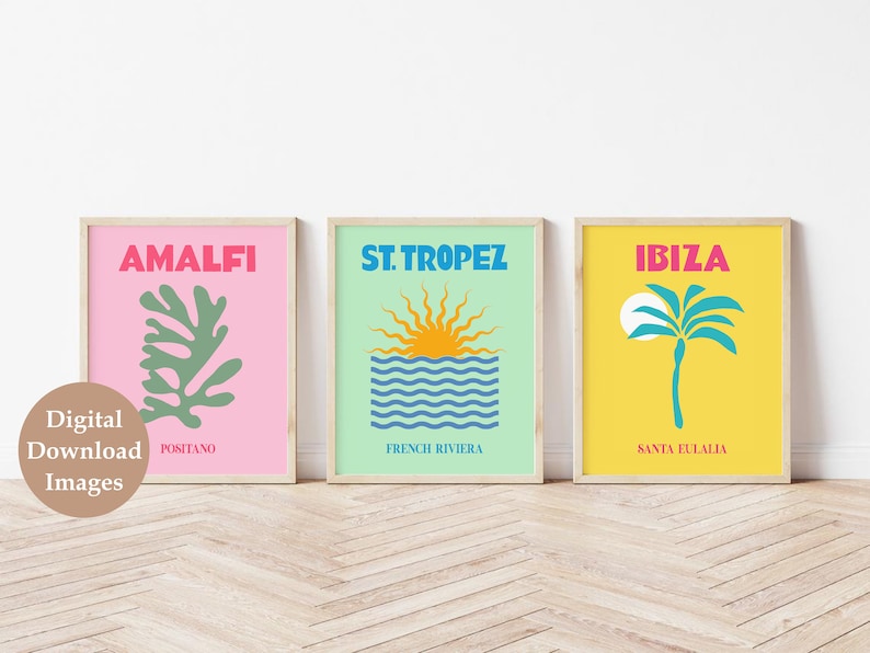 May include: Three framed prints with a minimalist design. The first print is pink with a green leaf and the text "Amalfi Positano". The second print is light green with a blue and white wave and a yellow sun with the text "St. Tropez French Riviera". The third print is yellow with a blue palm tree and the text "Ibiza Santa Eulalia".