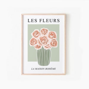 May include: A framed print with the text "LES FLEURS LA MAISON BOHEME" in black. The print features a bouquet of pink roses in a green striped vase on a light green background.