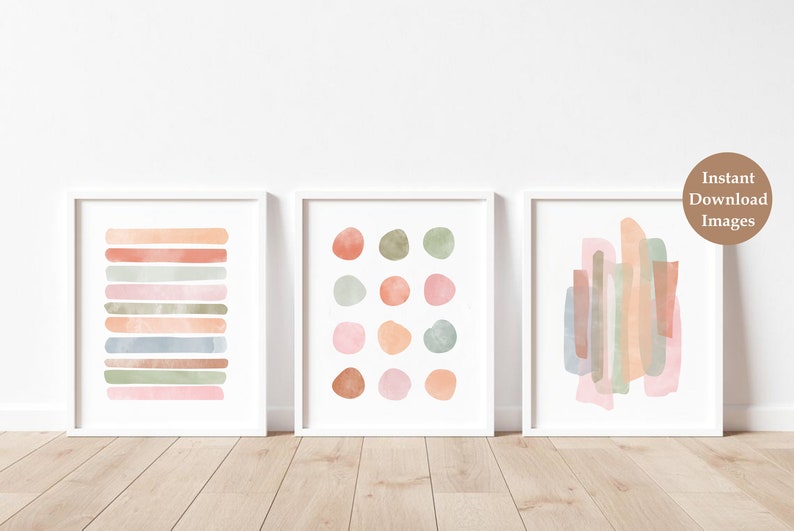 May include: Set of three abstract watercolor prints in muted pink, green, and brown tones. The prints feature geometric shapes and lines.