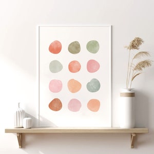 May include: A framed print with a white background and 15 abstract watercolor circles in shades of pink, orange, green, and brown.