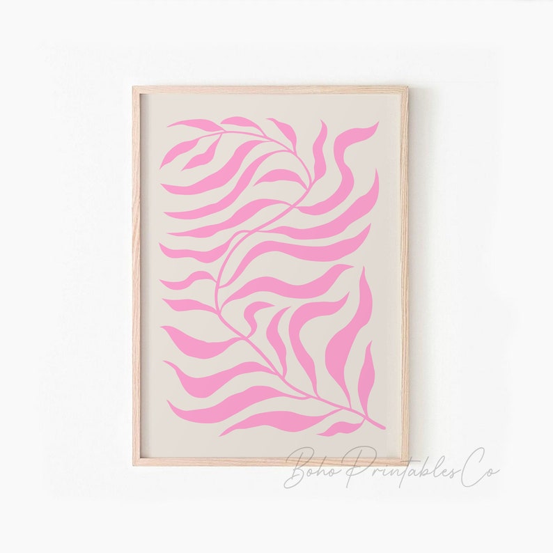 May include: A digital print of a pink stylized leaf design on a beige background. The print is framed in a light wood frame.