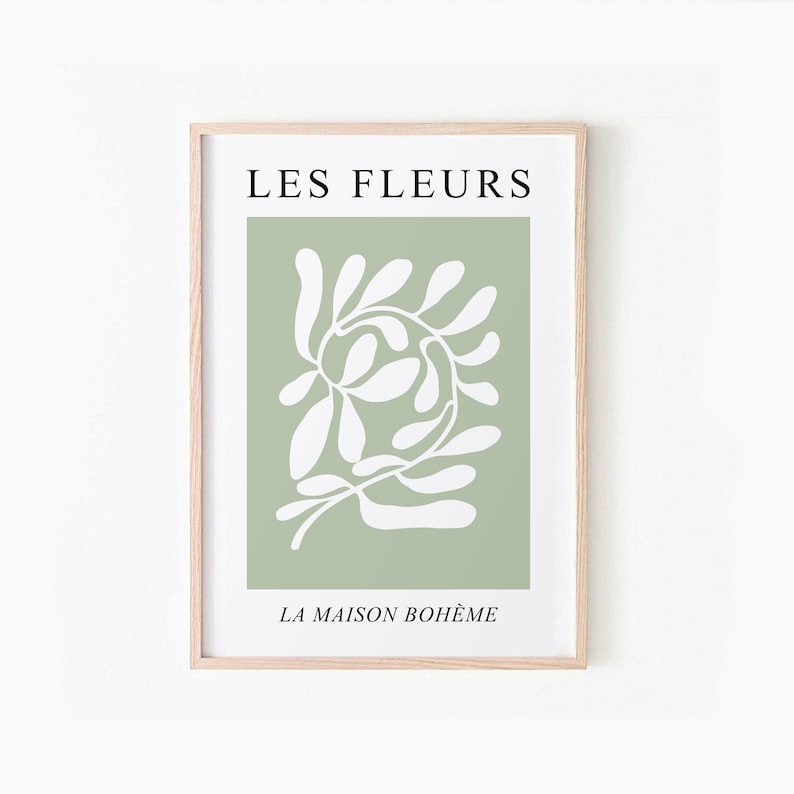 May include: A framed print with a green background and a white abstract floral design. The text "LES FLEURS" is at the top and "LA MAISON BOHEME" is at the bottom.