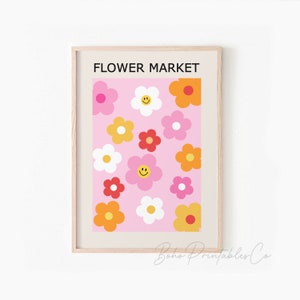 May include: A printable wall art design featuring a pink background with a repeating pattern of colorful flowers. The flowers are in shades of pink, red, yellow, and orange. The text "FLOWER MARKET" is at the top of the design.
