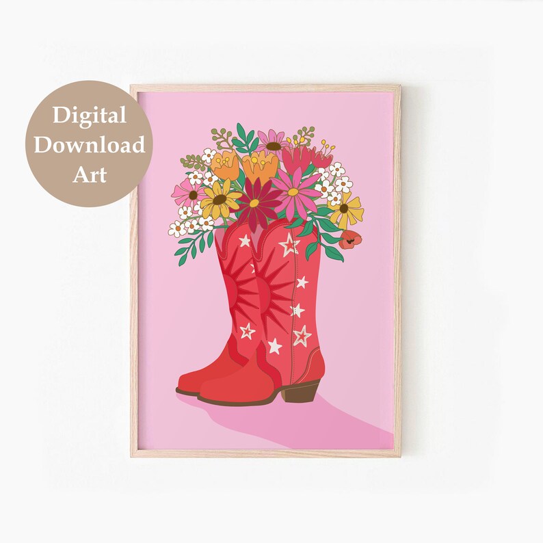 May include: A pair of red cowboy boots with white stars and a sun design are filled with a bouquet of colorful flowers, including pink, yellow, orange, and white flowers. The boots are on a pink background.