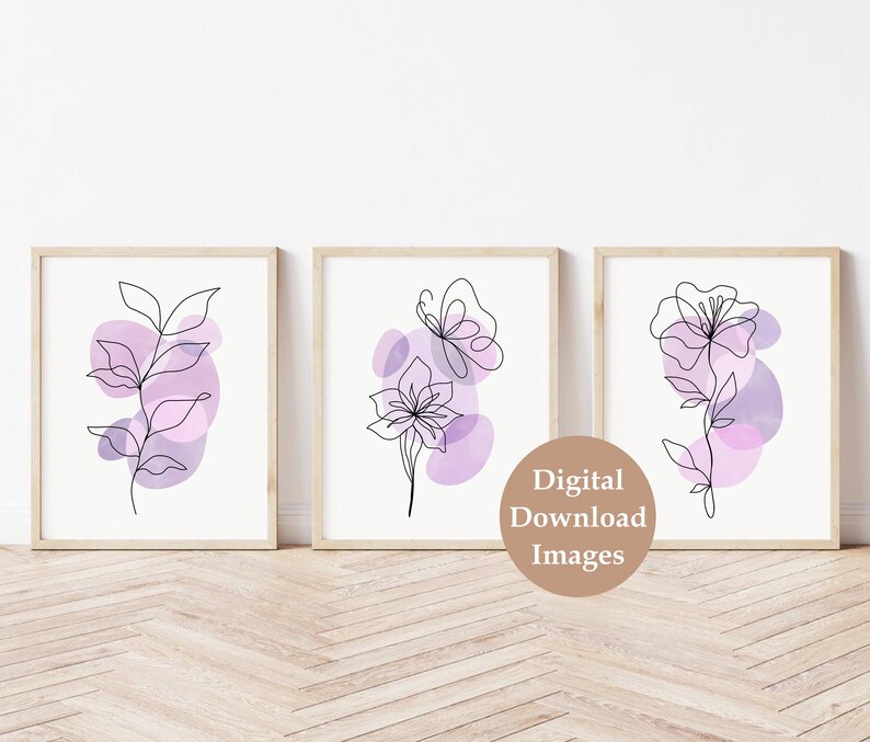 May include: Set of three digital prints featuring abstract line art floral designs with purple watercolour accents. The prints are framed and displayed on a white wall.